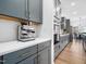 Galley kitchen with blue cabinets, quartz countertops, and stainless steel appliances, offers a sleek and functional space at 285 Scotland Dr, Youngsville, NC 27596