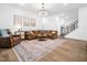 Comfortable living room with a large rug, brown sofa, and plenty of natural light, creating a warm atmosphere at 285 Scotland Dr, Youngsville, NC 27596
