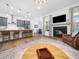 Open concept living room and kitchen with modern fireplace and island seating at 285 Scotland Dr, Youngsville, NC 27596
