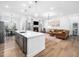 Open-concept space includes a kitchen island, living room with fireplace, and dining area for seamless entertaining at 285 Scotland Dr, Youngsville, NC 27596
