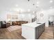 Open concept space featuring a modern kitchen island, a living room with a comfortable sofa and stylish decor at 285 Scotland Dr, Youngsville, NC 27596