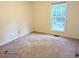 A simple, carpeted bedroom with a window that provides natural light at 3011 Little Creek Ln, Hillsborough, NC 27278