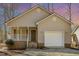 Charming house with a covered porch, garage, and a well-maintained yard shows great attention to detail at 3011 Little Creek Ln, Hillsborough, NC 27278