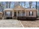 A well-maintained one-story home with a covered porch, adding curb appeal at 3011 Little Creek Ln, Hillsborough, NC 27278
