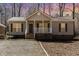 Charming single story home with a covered front porch and mature trees at 3011 Little Creek Ln, Hillsborough, NC 27278