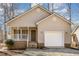 Charming home featuring a welcoming front porch and an attached garage at 3011 Little Creek Ln, Hillsborough, NC 27278