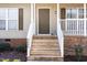 Front door entrance showcasing wood steps and railings at 3011 Little Creek Ln, Hillsborough, NC 27278
