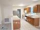 Functional kitchen featuring white appliances, wooden cabinetry and breakfast bar at 3011 Little Creek Ln, Hillsborough, NC 27278