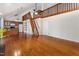 Bright living space with hardwood floors, a wooden staircase, and open kitchen layout at 3011 Little Creek Ln, Hillsborough, NC 27278