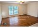 Spacious living room with hardwood flooring, a large window and neutral walls at 3011 Little Creek Ln, Hillsborough, NC 27278
