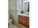 Bathroom features a toilet and a wood vanity with a large mirror at 323 Ranch Farm Rd, Raleigh, NC 27603