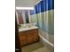 Cozy bathroom features a wood vanity, patterned tile floor and shower with curtain at 323 Ranch Farm Rd, Raleigh, NC 27603