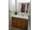 Bathroom features a wood vanity, a tile floor and a large mirror above the sink at 323 Ranch Farm Rd, Raleigh, NC 27603