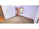 View of a carpeted bedroom that has a door to the hallway at 323 Ranch Farm Rd, Raleigh, NC 27603
