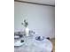 Stylishly set dining table featuring blue plates and a decorative centerpiece at 323 Ranch Farm Rd, Raleigh, NC 27603