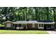 Lovely brick home with a covered carport, accented by colorful flowers and a well-maintained lawn at 323 Ranch Farm Rd, Raleigh, NC 27603