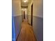 A view of a well-lit hallway with neutral paint and wood trim at 323 Ranch Farm Rd, Raleigh, NC 27603