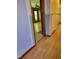 Hallway featuring wood-look floors and a doorway leading to another room at 323 Ranch Farm Rd, Raleigh, NC 27603