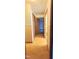 View of the hallway with wooden floors and neutral-colored walls leading to other rooms in the home at 323 Ranch Farm Rd, Raleigh, NC 27603