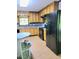 Well-lit kitchen with wooden cabinets, modern appliances, and tile flooring at 323 Ranch Farm Rd, Raleigh, NC 27603
