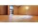 Spacious living room featuring wood paneling and an open doorway at 323 Ranch Farm Rd, Raleigh, NC 27603