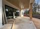 View of the covered porch with natural wood beams and concrete flooring at 3321 Founding Place, Raleigh, NC 27612