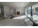 Spacious unfinished living room with a fireplace and large sliding glass door at 3321 Founding Place, Raleigh, NC 27612
