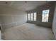Living room under construction with windows offering natural light and views at 3321 Founding Place, Raleigh, NC 27612