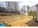The backyard deck has a railing and chairs overlooking the lawn at 3528 Dewing Dr, Raleigh, NC 27616
