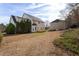 Expansive backyard featuring a wooden deck, mature trees, and a detached garage at 3528 Dewing Dr, Raleigh, NC 27616