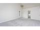 Spacious carpeted bedroom featuring ample natural light and a view into the bathroom at 3528 Dewing Dr, Raleigh, NC 27616