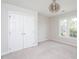Neutral bedroom featuring a neutral palette, carpet, closet, and modern light fixture at 3528 Dewing Dr, Raleigh, NC 27616