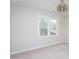 Well-lit bedroom featuring a neutral palette, carpet, and a stylish light fixture at 3528 Dewing Dr, Raleigh, NC 27616