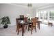 Formal dining room with wood table, chandelier, and a large window providing plenty of natural light at 3528 Dewing Dr, Raleigh, NC 27616