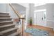 Inviting foyer with a staircase, hardwood floors, and a view into the dining area at 3528 Dewing Dr, Raleigh, NC 27616