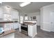 Bright kitchen featuring white cabinets, stainless steel appliances, and warm granite countertops at 3528 Dewing Dr, Raleigh, NC 27616