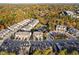 A high angle view of a residential community nestled in a colorful forest in autumn, featuring a central pond at 357 Roberts Ridge Dr, Cary, NC 27513