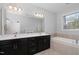 Well-lit bathroom with a large mirror, double sinks, and a separate soaking tub for relaxation at 357 Roberts Ridge Dr, Cary, NC 27513