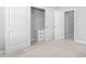 Carpeted bedroom with closet featuring integrated drawers and sliding doors at 357 Roberts Ridge Dr, Cary, NC 27513