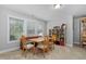 Sunlit dining area with a wooden table, chairs, and built-in bench seating at 357 Roberts Ridge Dr, Cary, NC 27513