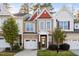 Charming townhome with a brick facade, attached garage, and well-manicured landscaping at 357 Roberts Ridge Dr, Cary, NC 27513