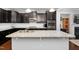 Modern kitchen featuring granite countertops, dark cabinets, stainless steel appliances, and a spacious island at 357 Roberts Ridge Dr, Cary, NC 27513