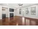 Spacious living room boasts gleaming hardwood floors, a fireplace, and a doorway to the outside at 357 Roberts Ridge Dr, Cary, NC 27513