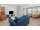 Comfortable living room with large blue sofa, TV, and an adjacent dining area at 357 Roberts Ridge Dr, Cary, NC 27513