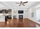 Open-concept living room showcasing a fireplace, hardwood floors, and seamless flow into the modern kitchen at 357 Roberts Ridge Dr, Cary, NC 27513