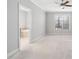 Large main bedroom with carpet flooring and a window, with a glimpse of the ensuite bathroom at 357 Roberts Ridge Dr, Cary, NC 27513