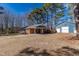 Cozy brick home featuring a detached blue garage and a large driveway, with a well-manicured lawn at 388 Holland Dr, Smithfield, NC 27577