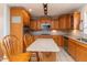 Classic eat-in kitchen offering ample wooden cabinetry, granite countertops, and modern stainless steel appliances at 388 Holland Dr, Smithfield, NC 27577