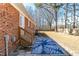 Patio with a patterned blue rug, wooden stairs, and brick exterior at 388 Holland Dr, Smithfield, NC 27577