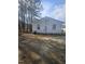 The backyard is covered in pine needles with woods in the background at 4805 Barbee Rd, Durham, NC 27713